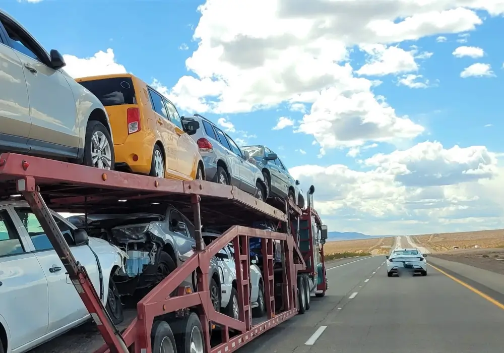 a bulk of car loaded on a truck for shipping