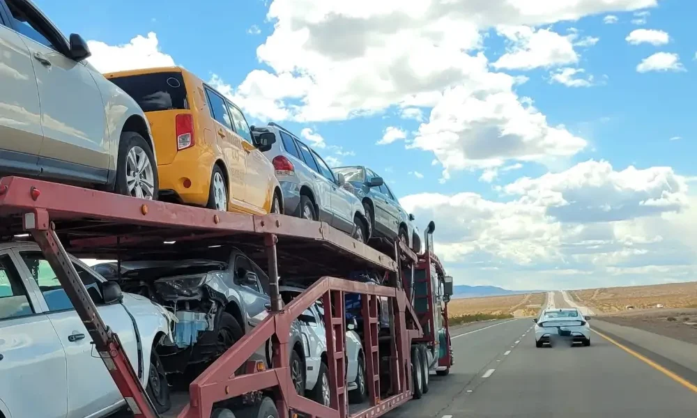 a bulk of car loaded on a truck for shipping